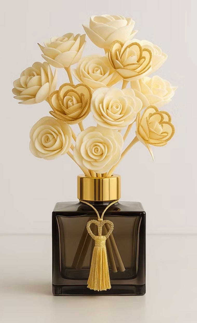 Skip the Roses Forever Rose Diffuser with ivory rose-shaped blooms, a dark glass vessel, gold-tone collar and tassel.